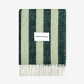 Striped Candy Wrap Blanket in green sage pattern and 'MAISON DEUX' label on a white background