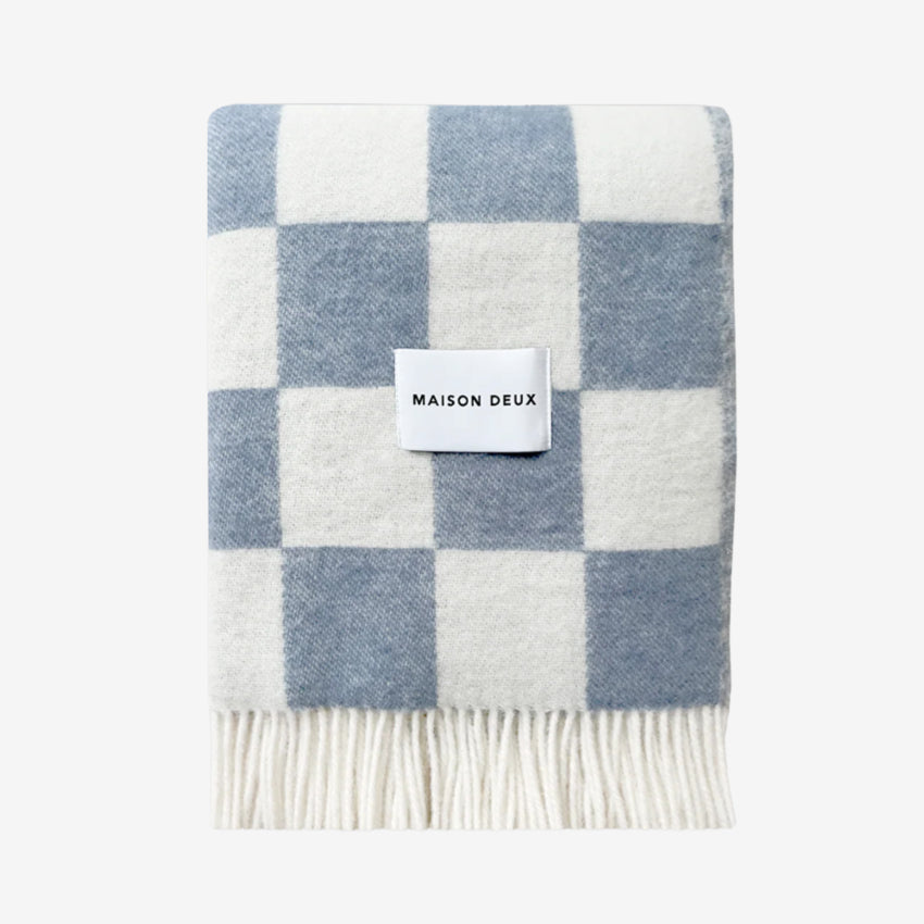 Checkerboard blanket in Denim with 'Maison Deux' label on a white background