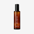The Matakana Essentials Room Spray brown bottle on a grey background