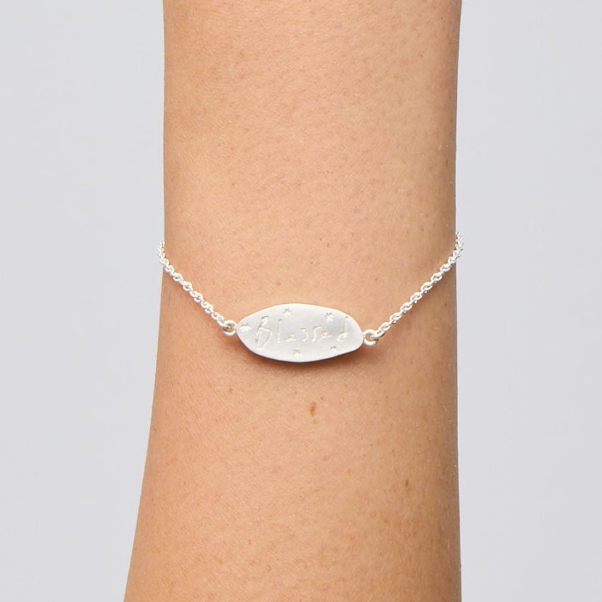 The Meadowlark Blessed Bracelet in Sterling Silver on a models wrist