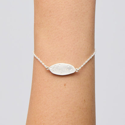 The Meadowlark Blessed Bracelet in Sterling Silver on a models wrist