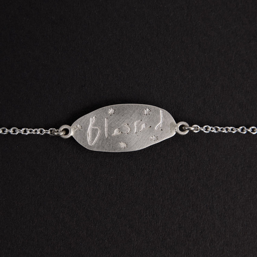 The Meadowlark Blessed Bracelet in Sterling Silver on a black felt
