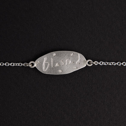 The Meadowlark Blessed Bracelet in Sterling Silver on a black felt