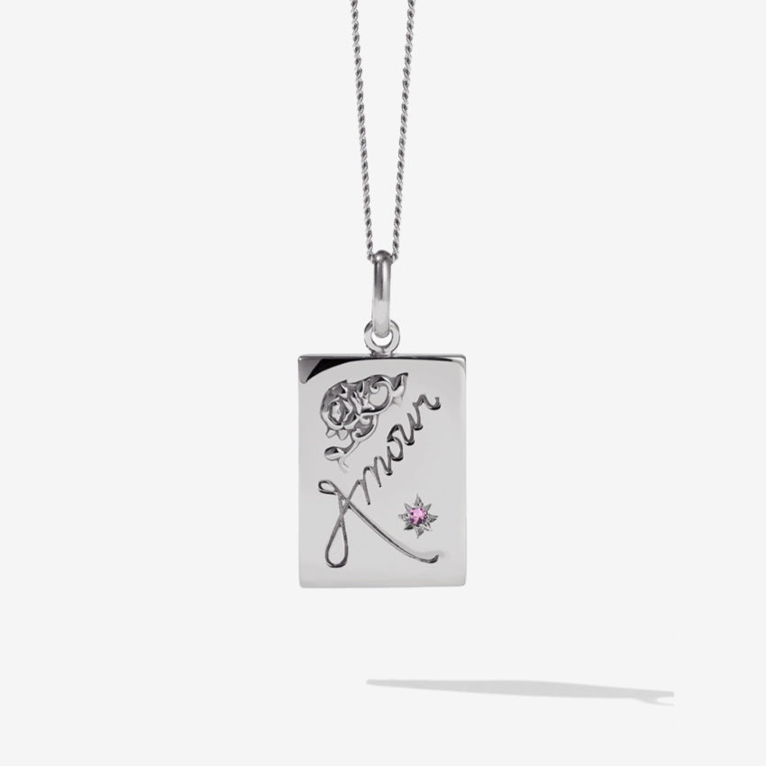 The Meadowlark Amour Necklance with a Pink Sapphire in Sterling Silver on a blank background.