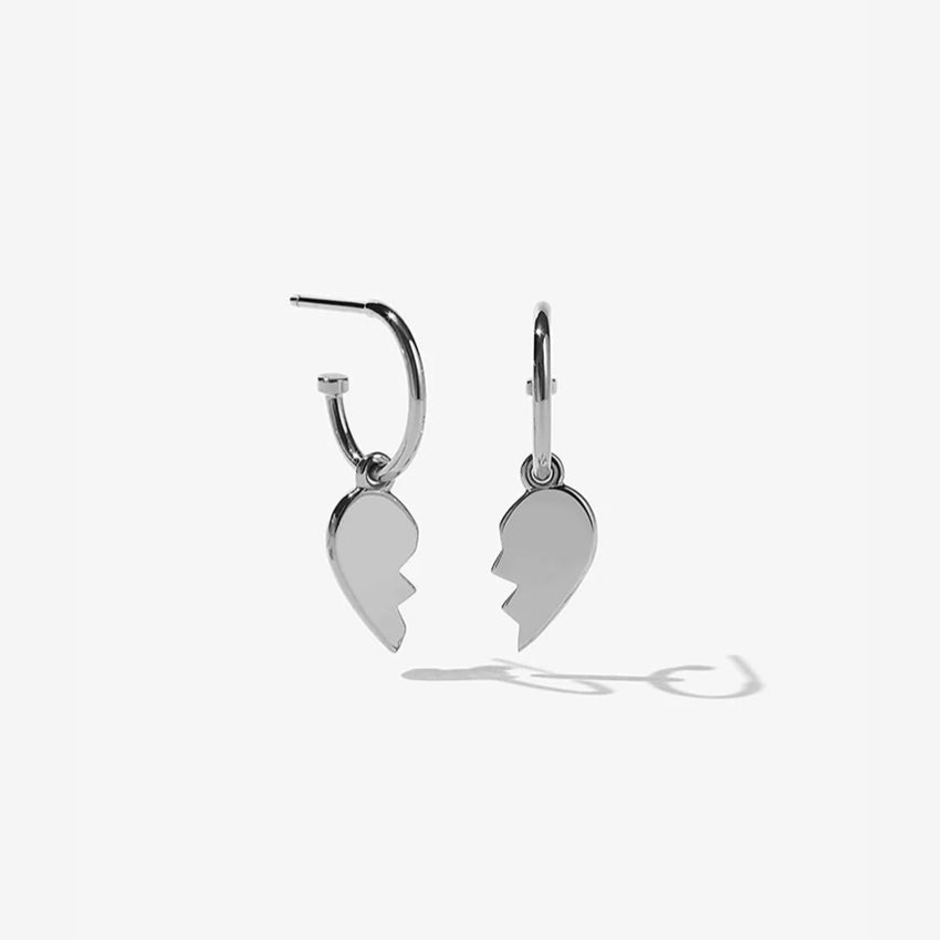 The Meadowlark Broken Heart Signature Hoops in Sterling Silver on a blank background
