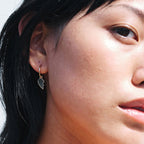 A model wearing the Meadowlark Broken Heart Signature Hoops in Gold Plated.