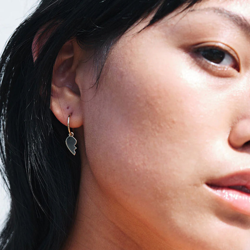 A model wearing the Meadowlark Broken Heart Signature Hoops in Gold Plated.