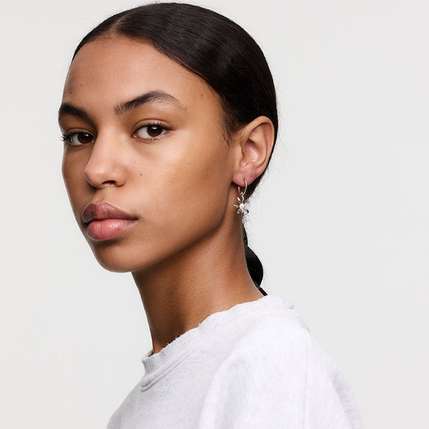 The Meadowlark Daisy Signature Hoops in Sterling Silver on a model