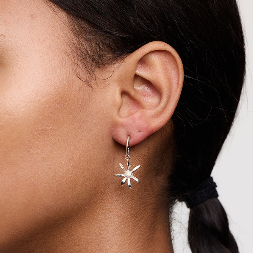 The Meadowlark Daisy Signature Hoops in Sterling Silver on a model