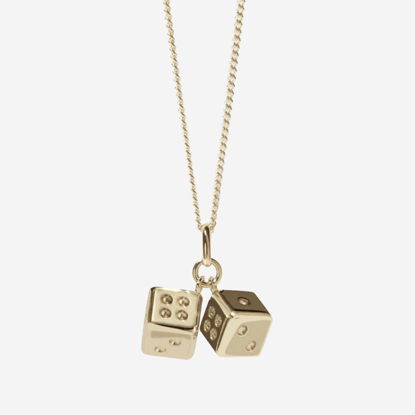 The Meadowlark Dice Charm Necklace in gold on a blank background