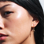 The Meadowlark Dove Signature Hoops in Gold Plated on a model