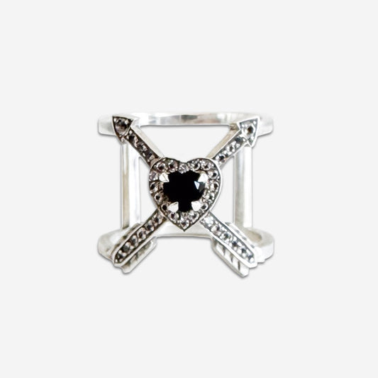 The Meadowlark Heart Arrow Cross Ring features an Onyx and White Topazes in Sterling Silver and on a blank background.