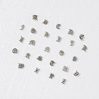 The full range of Meadowlark Letter Studs on a blank background