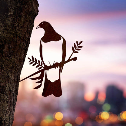 The Metalbird steel Kereru in a tree with twinkling lights in the background