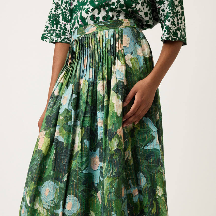 A close up of the Nancybird Alma Yoke Skirt in Garden Print on a model