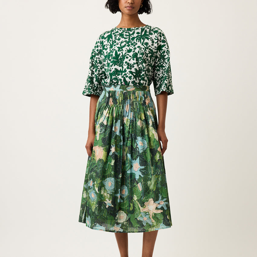 The Nancybird Alma Yoke Skirt in Garden Print on a model on a grey background