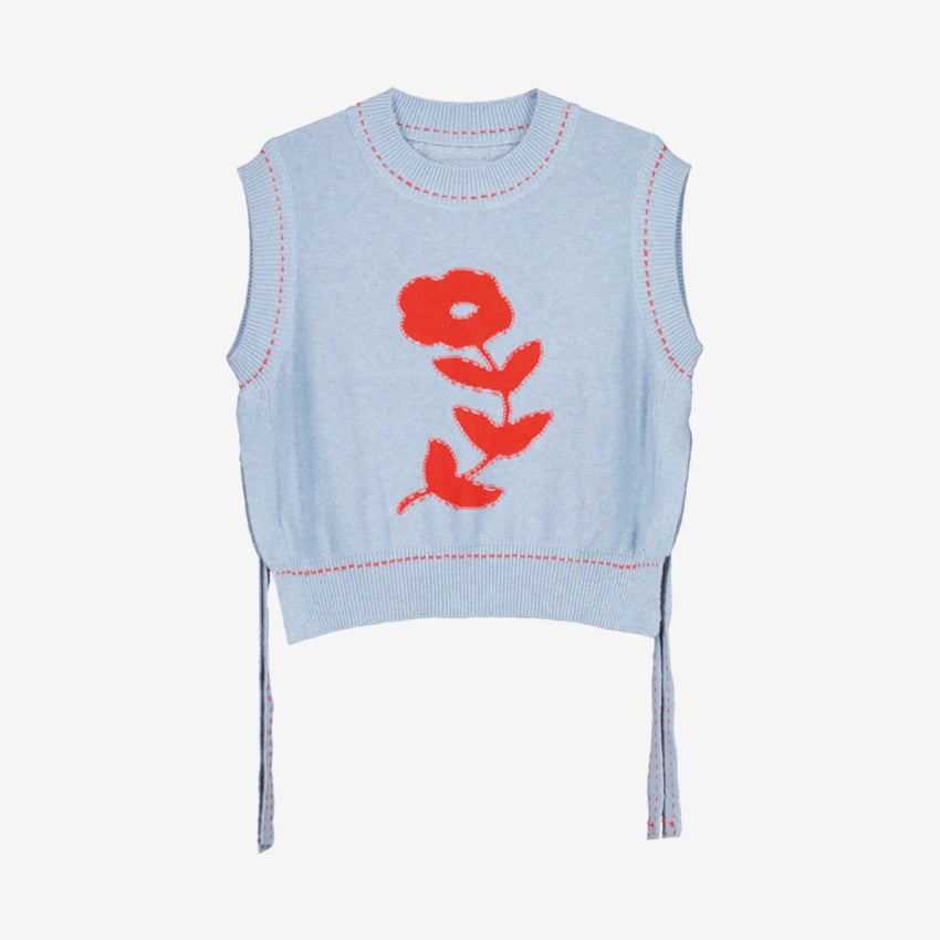 The Nancybird Aria Vest in Flower on a grey background