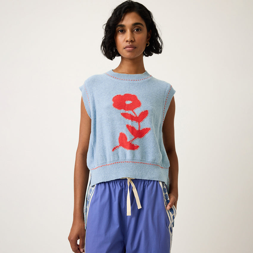 The Nancybird Aria Vest in Flower on a model on a grey background