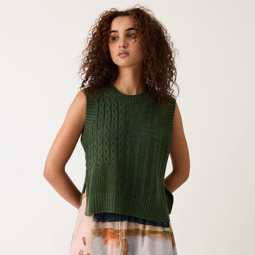 Nancybird Billie Cable Vest in Cypress Green on a model on a grey background