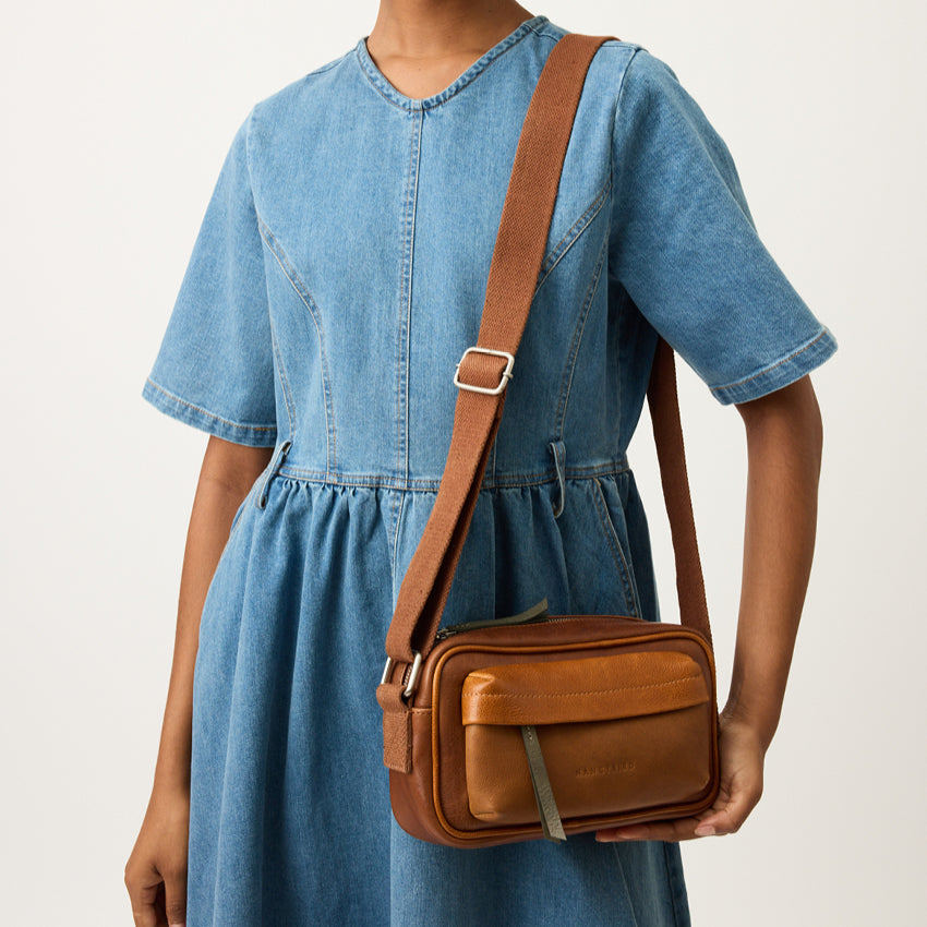 The Nancybird Goshen Bag in Tan on a models shoulder