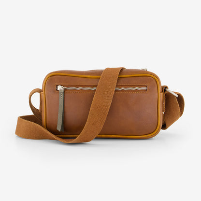 A back view of the Nancybird Goshen Bag in Tan on a grey background