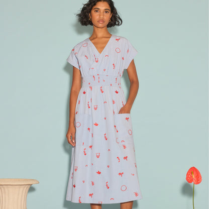 The Nancybird Hana Dress in Motif Embroidery on a model next to a vase and flower