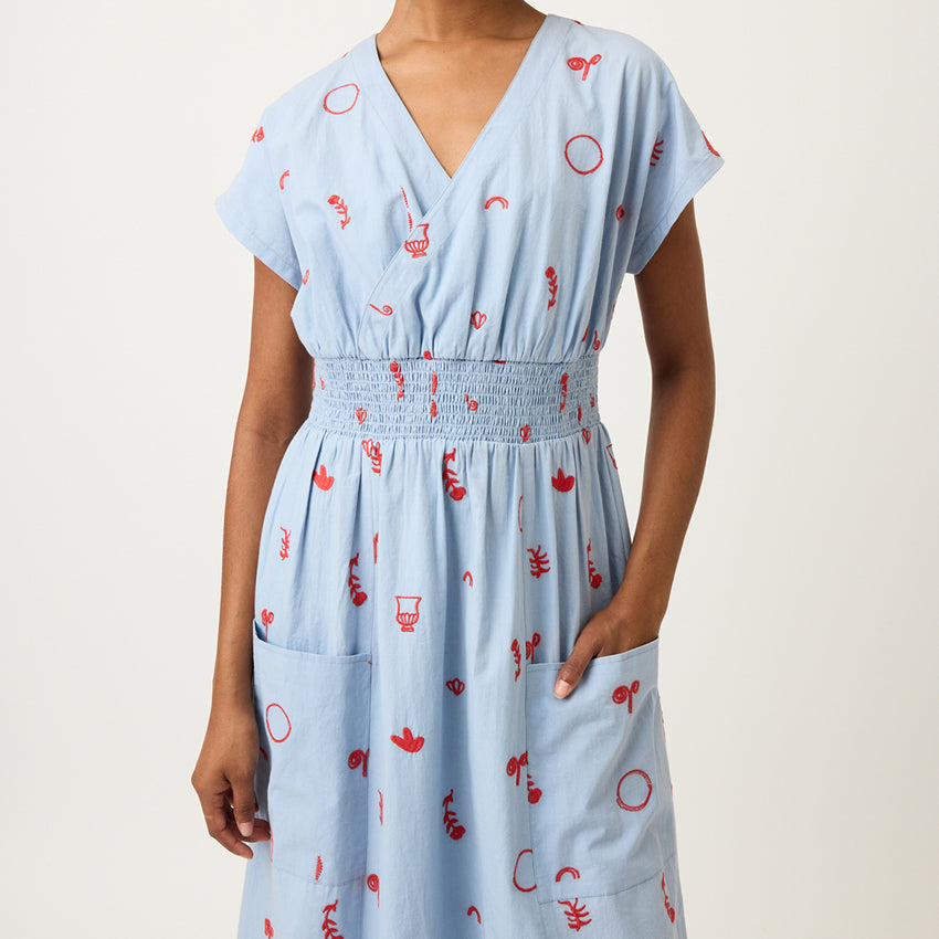 A closeup of the Nancybird Hana Dress in Motif Embroidery on a model