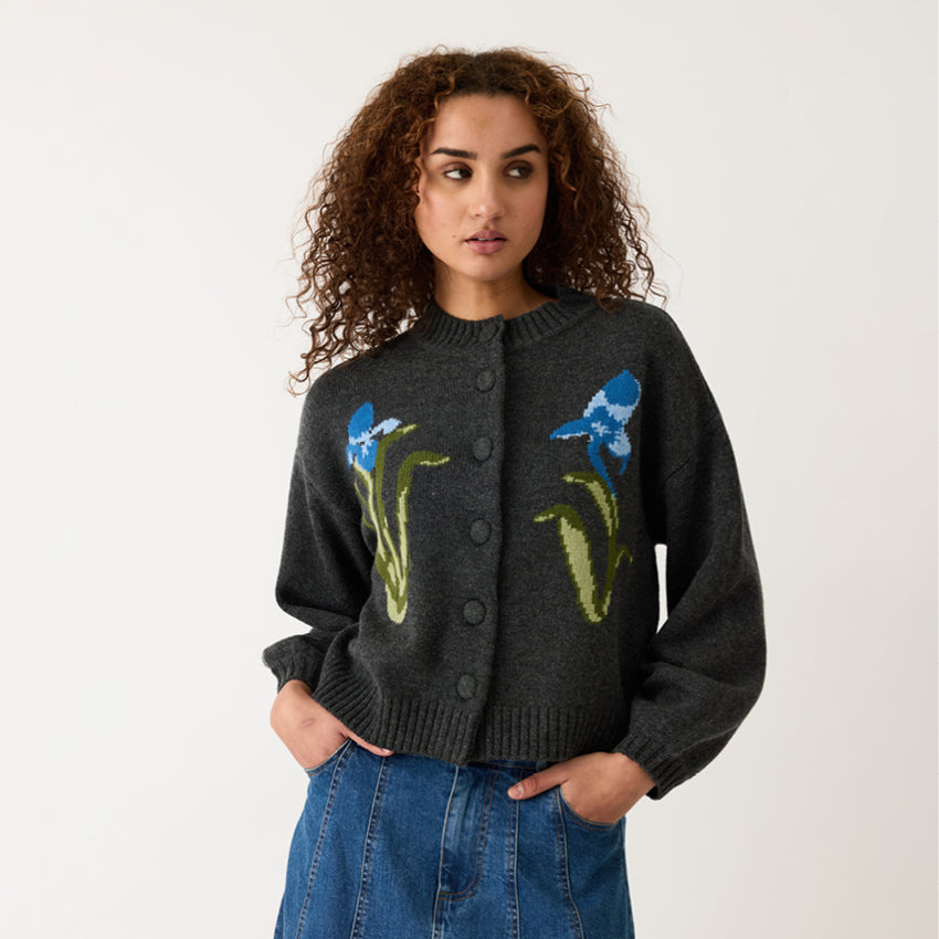 Model wearing the Nancybird Iris Cardigan on a grey background