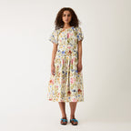 A model wearing the Nancybird Lola Dress in Watercolour Collage on a grey background