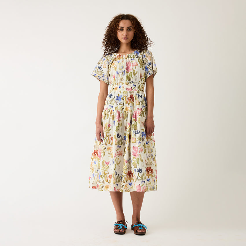 A model wearing the Nancybird Lola Dress in Watercolour Collage on a grey background