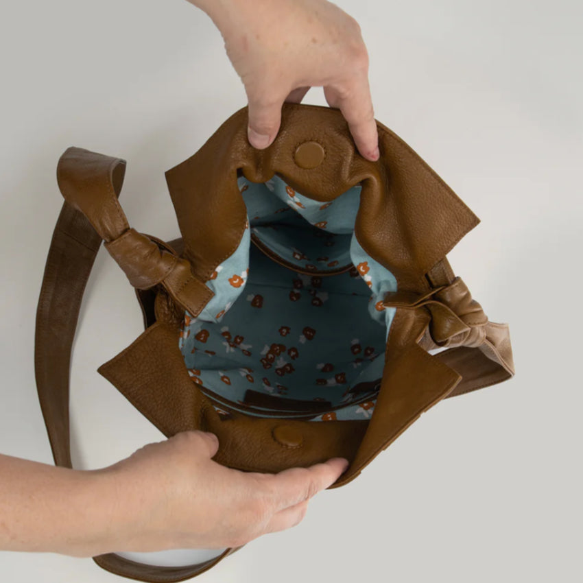 A above view of the Nancybird Shiki Bag in Tapenade inside being held open