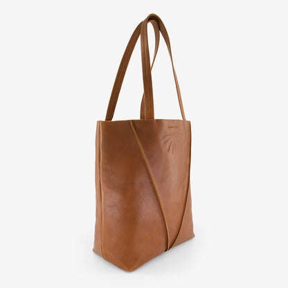 A side view of the Nancybird Tri Tote in Tobacco on a grey background