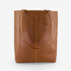 A back view of the Nancybird Tri Tote in Tobacco on a grey background