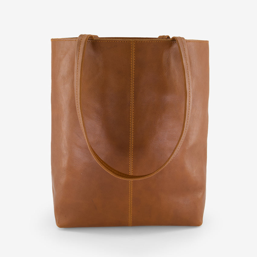 A back view of the Nancybird Tri Tote in Tobacco on a grey background
