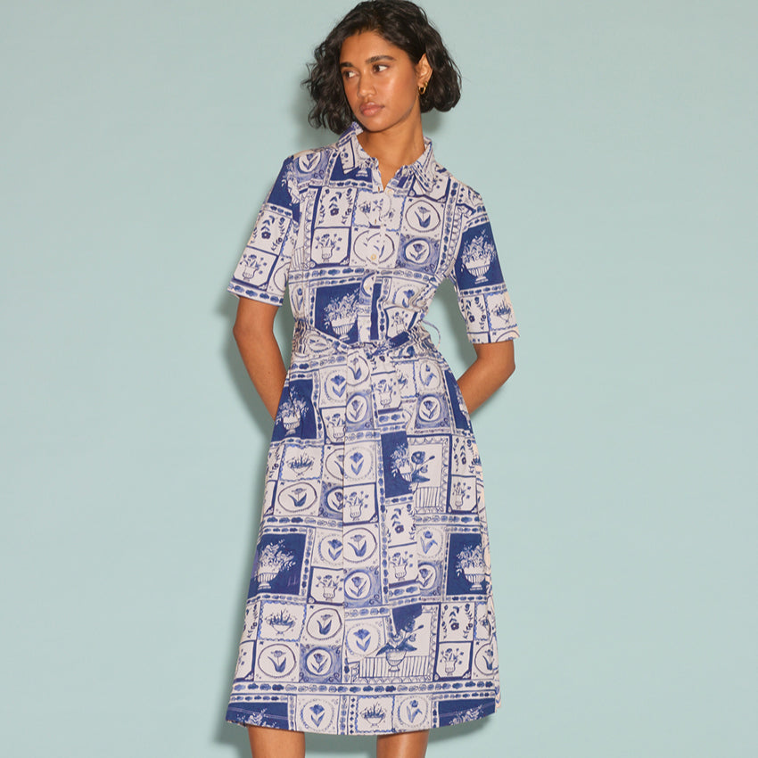 The Nancybird Vera Short Sleeve Dress in Lyon Tile on a model on a blue background