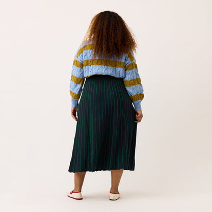 A back view of the Nancybird Aine Skirt in Foliage on a model on a blank background