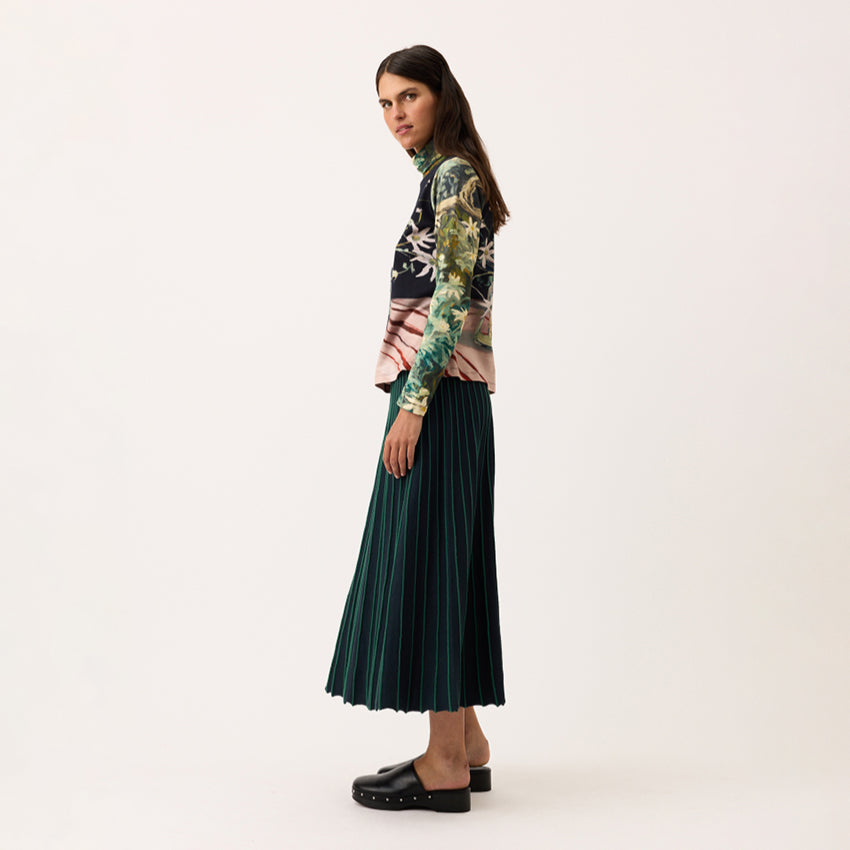 A side view of the Nancybird Aine Skirt in Foliage on a model on a blank background