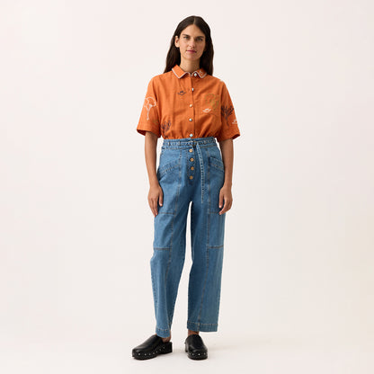 The Nancybird Amos Pant in Denim on a model on a blank background