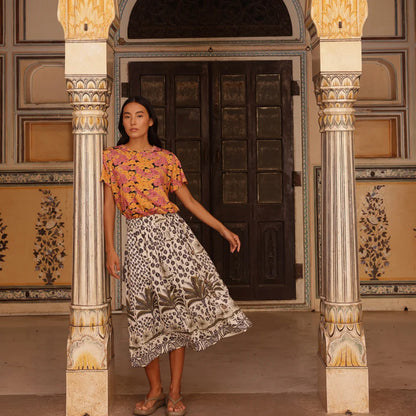 Nancybird Apollo Tee in Sunset Floral on a model paired with a skirt