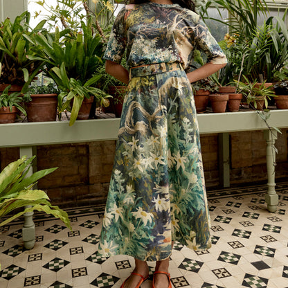 The Nancybird Aries Skirt in Flannel Flower on a model in a conservatory