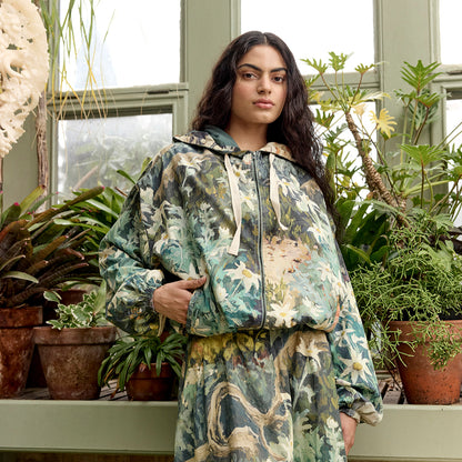 The Nancybird Bromley Jacket in Flannel Flower on a model with matching skirt next to plants