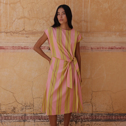 The Nancybird Cacey Dress in Dusk Stripe on a model in front of a cracked wall