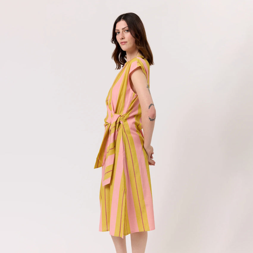 A side shot of the Nancybird Cacey Dress in Dusk Stripe on a model on a blank background