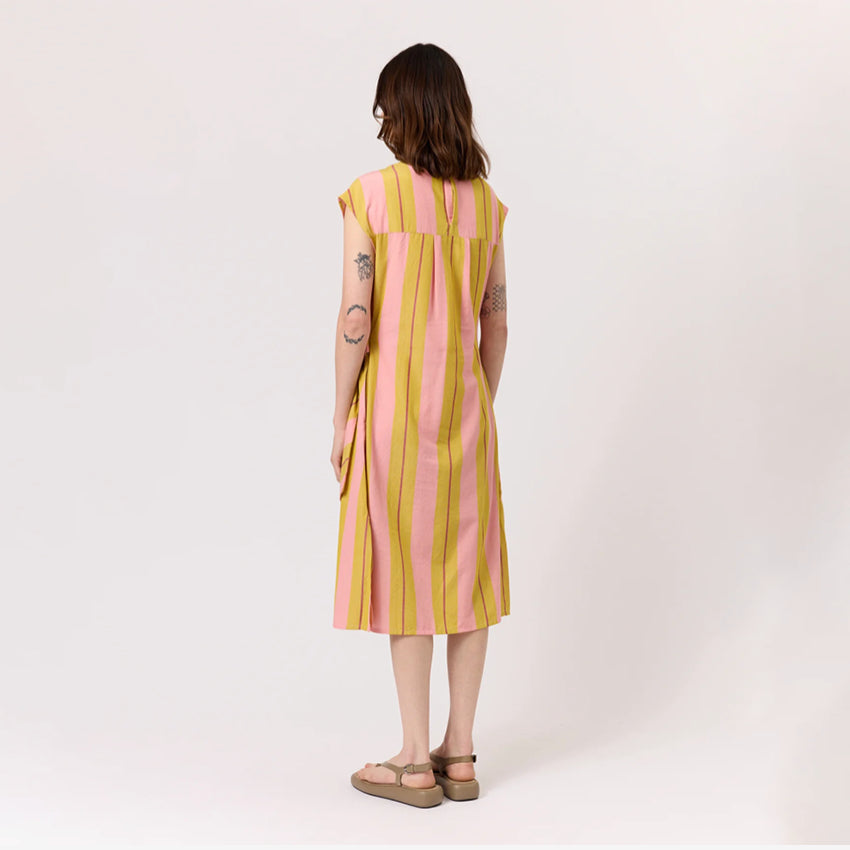 The back of the Nancybird Cacey Dress in Dusk Stripe on a model on a blank background