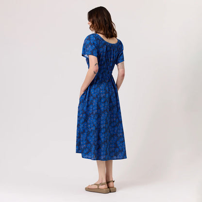 The back of the Nancybird Daphne Dress in Midnight Floral on a model on a blank background