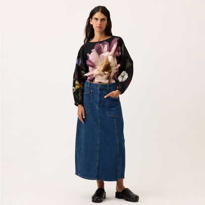 The Nancybird Franny Skirt in Denim on a model with a blank background