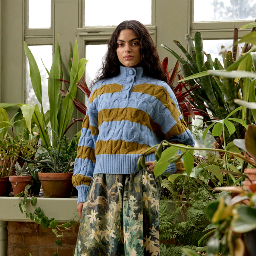 The Nancybird Gemma Cable Knit in Day Break on a model on a conservatory 