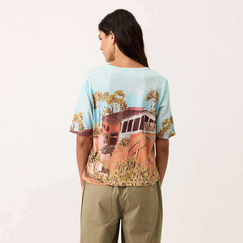 A back view of the Nancybird Grace Tee in Shack print on a model on a blank background