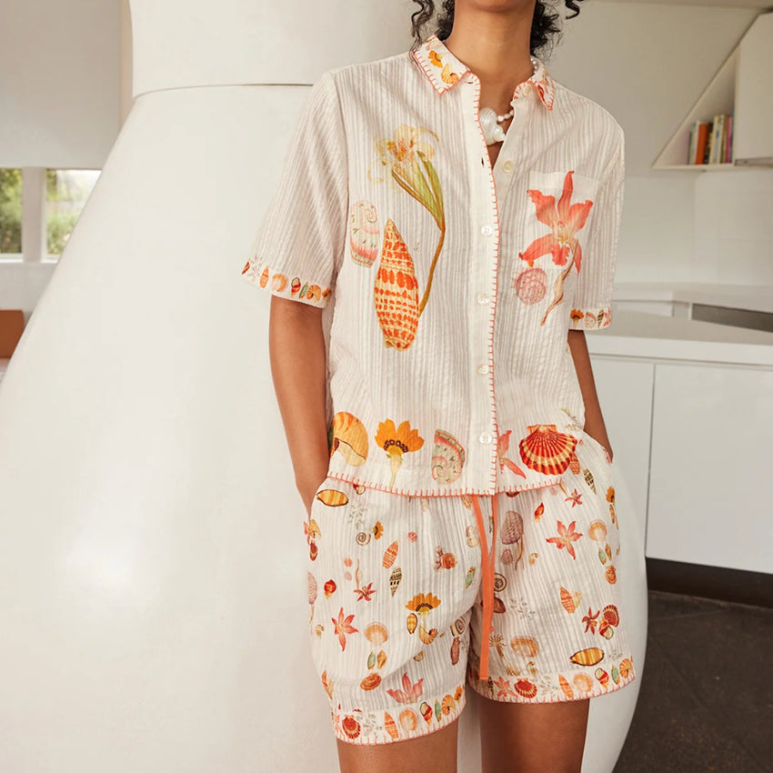 The Nancybird Iris Shorts in Cream Shell on a model with the matching shirt in a home