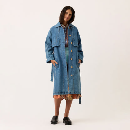 The Nancybird Linu Trench in Denim on a model on a blank background